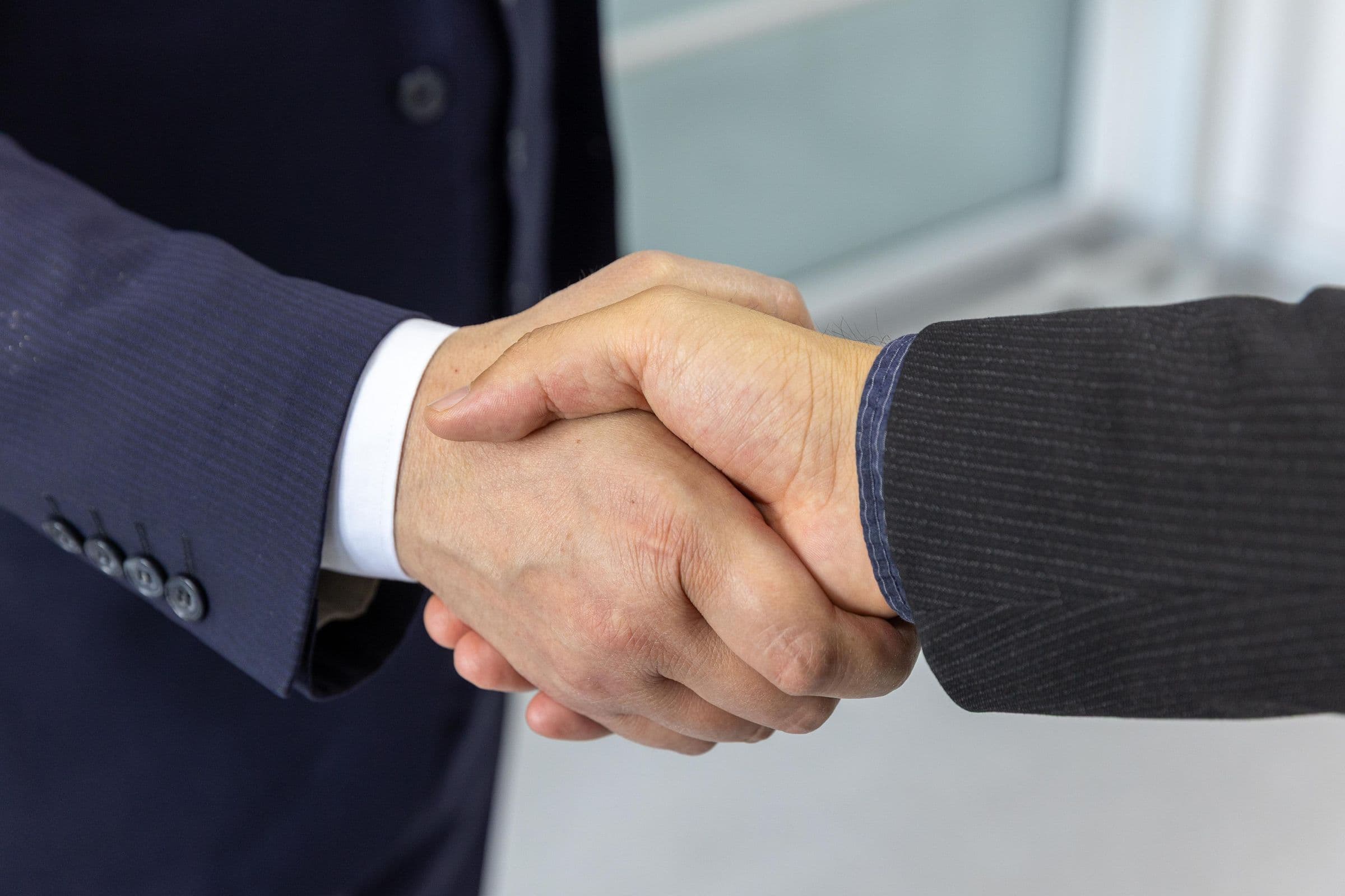 Two business partners shaking hands after reaching an agreement